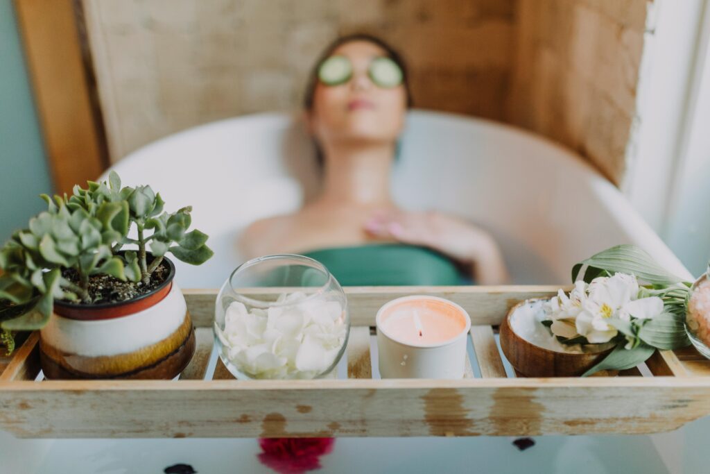 Woman in Green Tube Top Sitting on White Ceramic Bathtub