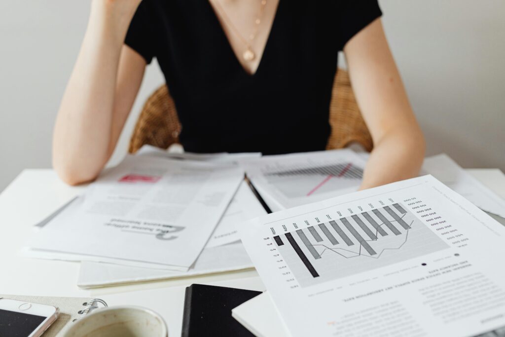 Close-up of financial documents and graphs on a desk, showcasing business analysis.